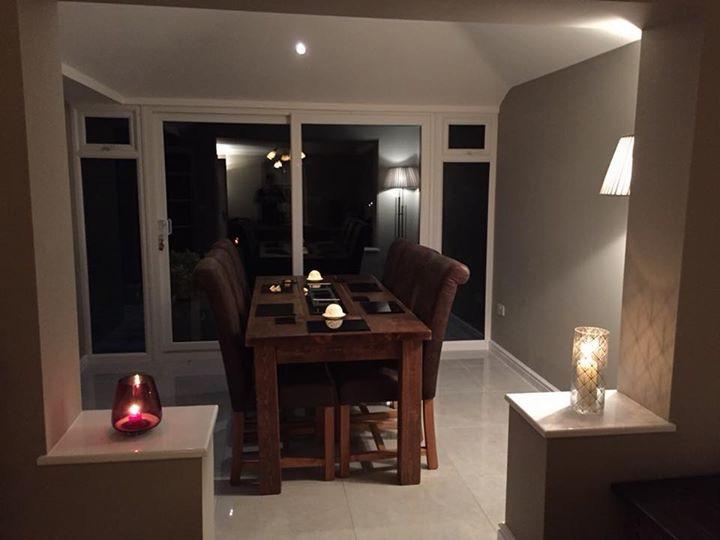 Smart-Roof conservatory used as a warm evening dining room with mood lighting
